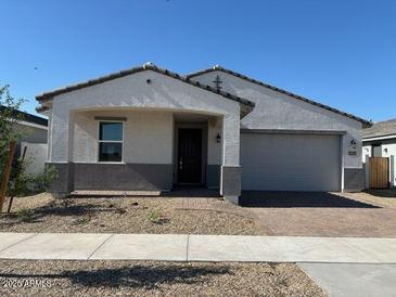Charming single-story home with a two-car garage and low maintenance desert landscaping at 17683 W Odeum Ln, Goodyear, AZ 85338
