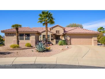 Charming single-story home featuring a tile roof, desert landscaping, and a welcoming front entrance at 19824 N Valencia Ct, Surprise, AZ 85374