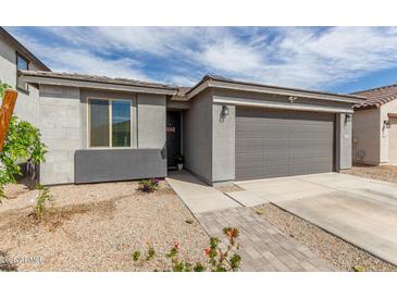Charming single-story home with a two-car garage, desert landscaping, and a welcoming front entrance at 36284 W San Clemente Ave, Maricopa, AZ 85138