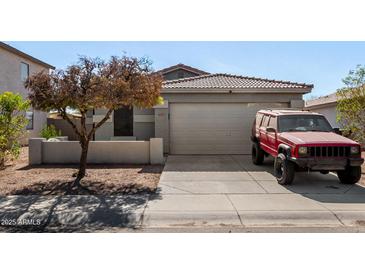 Charming home featuring a two-car garage and well-maintained landscaping, creating curb appeal at 6313 W Pioneer St, Phoenix, AZ 85043