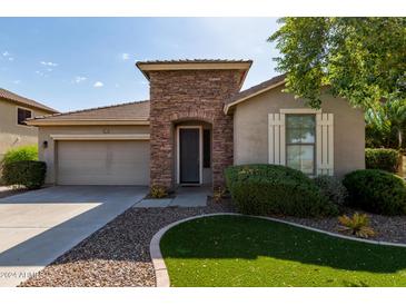 Charming single-story home with a stone-accented entry and well-manicured landscaping at 6993 S Ruby Dr, Chandler, AZ 85249