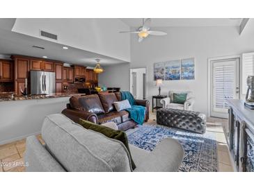 Inviting living room featuring a leather sofa, plush seating, and an open layout to the kitchen at 9708 E Via Linda -- # 2328, Scottsdale, AZ 85258