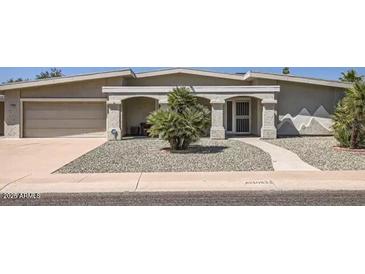 Charming single-story home with arched entryway and desert landscaping at 10822 W Mimosa Dr, Sun City, AZ 85373