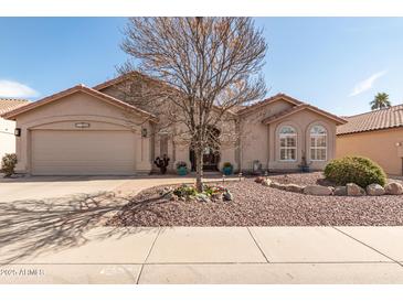 Charming one-story home featuring a neutral exterior, manicured landscaping, and a two-car garage at 11445 S 44Th St, Phoenix, AZ 85044