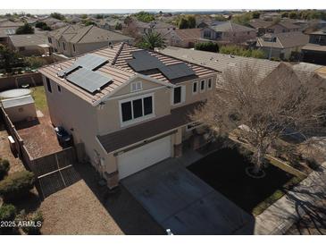 Inviting two-story home with solar panels and a well-manicured front yard in a Gathering-friendly neighborhood at 15137 W Yucatan Dr, Surprise, AZ 85379