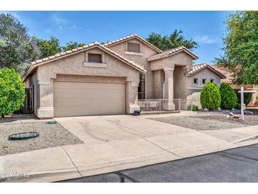 Charming home featuring a two-car garage, inviting front yard, and desert landscaping at 17620 W Weatherby Dr, Surprise, AZ 85374