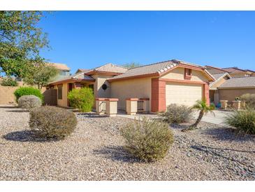 Charming single-story home with low-maintenance desert landscaping and a two-car garage at 23836 W Jefferson St, Buckeye, AZ 85396