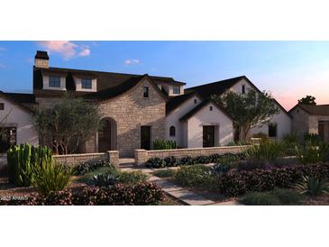 Beautiful stone and stucco home with manicured desert landscaping and paver walkway at 27864 N 158Th Ave, Surprise, AZ 85387