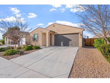 Charming single-level home featuring a two-car garage, a well-maintained yard, and a cozy entrance at 378 W Satinka Dr, San Tan Valley, AZ 85140