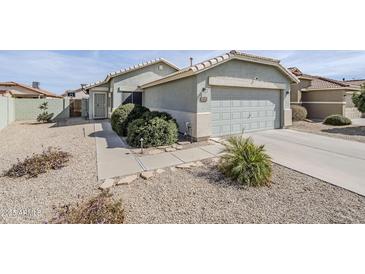 Charming single-story home with a well-maintained yard and attached two-car garage at 39935 N Passaro Dr, San Tan Valley, AZ 85140