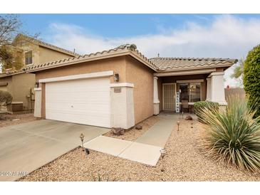 Charming single-story home with a two-car garage and well-maintained front yard at 40656 N Key Ln, Anthem, AZ 85086