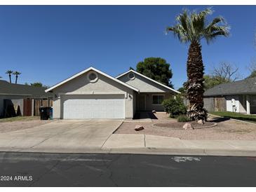 Charming single-Gathering home with a two-car garage, desert landscaping, and a mature palm tree at 614 W 7Th Ave, Mesa, AZ 85210