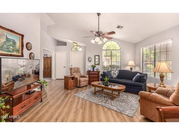 Spacious living room with vaulted ceilings, modern ceiling fan, and wood-look flooring at 855 E Vaughn Ave, Gilbert, AZ 85234