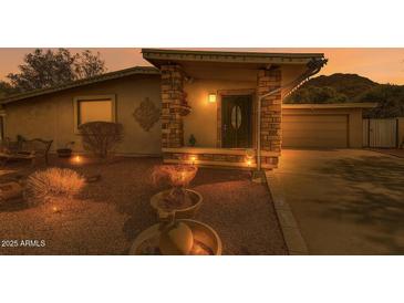 Charming home with stone accents, a well-manicured yard, and a cozy front porch at 9031 N 14Th St, Phoenix, AZ 85020