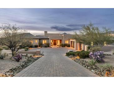 Stunning home features a desert landscape, brick driveway, and grand entrance at 10238 E Rising Sun Dr, Scottsdale, AZ 85262