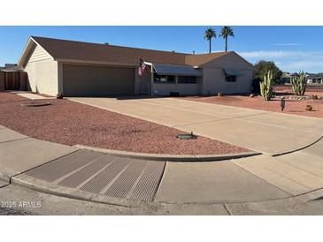 Charming single story home with mature landscaping and a circular driveway at 10402 N Balboa Dr, Sun City, AZ 85351