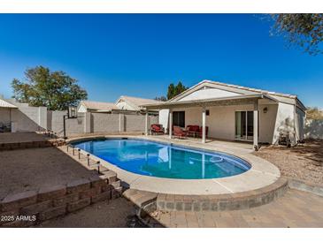 Backyard pool with patio seating, and a basketball hoop for outdoor fun and relaxation at 1345 W Diamond Ave, Apache Junction, AZ 85120