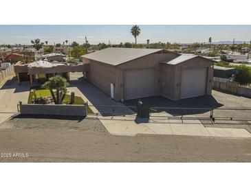 Wide angle of garage, gated yard, block wall and palm trees at 1373 E 23Rd Ave, Apache Junction, AZ 85119