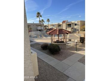 Community pool with a pergola and seating available to residents at 16635 N Cave Creek Rd # 213, Phoenix, AZ 85032