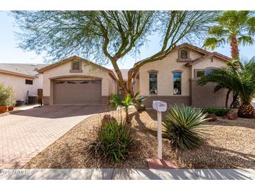 Charming single-story home featuring well-maintained landscaping and a two-car garage at 18261 W Weatherby Dr, Surprise, AZ 85374