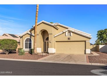 Charming single-story home with arched entryway, desert landscaping, and attached two car garage at 19185 N 116Th Ln, Surprise, AZ 85378