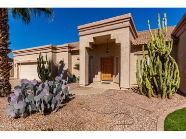 Charming home with desert landscaping, stone pavers, a decorative front door, and a covered entryway at 20386 E Bronco Dr, Queen Creek, AZ 85142
