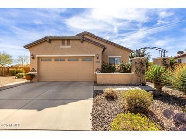 Charming single-story home featuring a well-manicured front yard and a two-car garage at 26057 W Sequoia Dr, Buckeye, AZ 85396