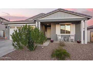 Inviting home exterior with rocking chairs on the front porch and a well-maintained yard at 28883 N 131St Dr, Peoria, AZ 85383