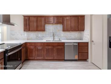 This kitchen features custom cabinets, stainless steel appliances, and granite countertops at 2907 S Elm St, Tempe, AZ 85282