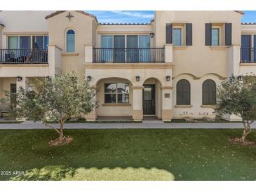 Charming townhome with covered entry, balcony, manicured lawn, and beautiful architectural details at 4020 E Toledo St # 103, Gilbert, AZ 85295