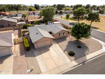 An aerial view showcases the property's tidy yard, driveway, and charming single-story home at 7309 E Diamond Ave, Mesa, AZ 85208