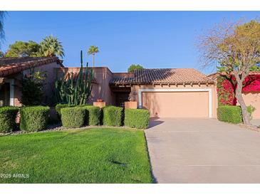 Charming single-story home with desert landscaping, tile roof, and attached two-car garage at 8138 E Via De La Escuela --, Scottsdale, AZ 85258