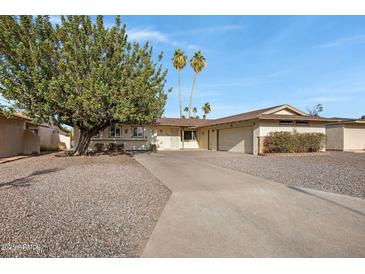 Charming single-story home with desert landscaping, long driveway and a two car garage at 829 S Revolta Cir, Mesa, AZ 85208