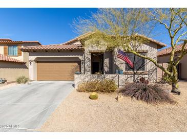 Charming single-story home with a desert-landscaped front yard and a two-car garage at 9260 E Greenway St, Mesa, AZ 85207