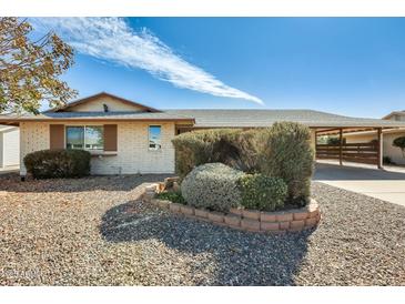 Charming single-story home featuring low-maintenance landscaping and an attached covered carport at 10025 W Alabama Ave, Sun City, AZ 85351