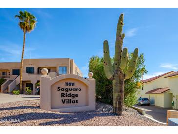 Desert landscaping highlights the Saguaro Ridge Villas sign on a bright sunny day at 11011 N Zephyr Dr # 106, Fountain Hills, AZ 85268