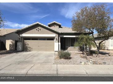 Charming single story home with desert landscaping, two car garage, and covered porch at 11946 W Jackson St, Avondale, AZ 85323