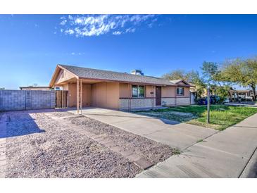 Charming single story home with neutral paint, covered carport, and low maintenance gravel yard at 1340 N Oregon St, Chandler, AZ 85225