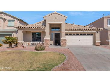 Charming single-story home featuring a two-car garage and landscaped front yard at 16102 W Miami St, Goodyear, AZ 85338