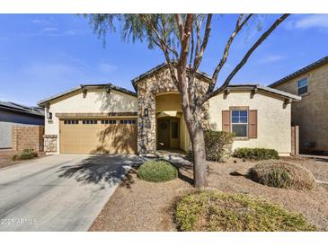 Charming single-Gathering home featuring stone accents, desert landscaping, and a welcoming facade at 17138 W Las Palmaritas Dr, Waddell, AZ 85355