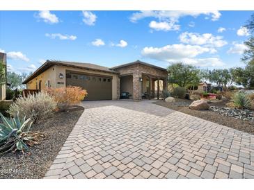 A charming single-story home with a paved driveway, desert landscaping, and a two-car garage at 17963 E Silver Sage Ln, Rio Verde, AZ 85263