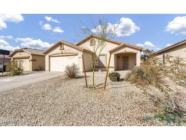 Charming single-story home featuring low-maintenance desert landscaping and an attached two-car garage at 1992 E Shetland Dr, San Tan Valley, AZ 85140