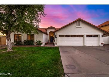 Charming home with a three-car garage, lush lawn, and tile roof in front exterior view at 2646 N Robin Ln, Mesa, AZ 85213