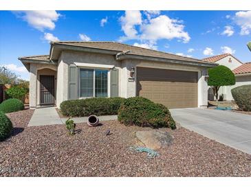 Charming single-story home boasts a low-maintenance desert landscape and a neutral-toned facade at 27108 W Escuda Dr, Buckeye, AZ 85396