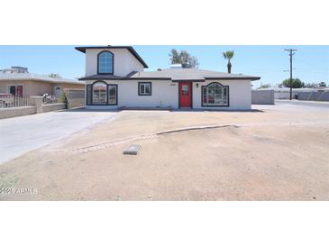 Charming home with a red front door, large windows, and a unique two-story design at 3547 W Encanto Blvd, Phoenix, AZ 85009