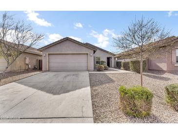 Charming single-story home featuring a two-car garage, gravel landscaping, and a welcoming entrance at 36852 N Yellowstone Dr, San Tan Valley, AZ 85140