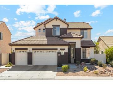 Charming two-story home showcasing a three-car garage and a well-maintained, low-water, desert-style front yard at 4043 W Aire Libre Ave, Phoenix, AZ 85053