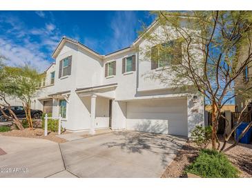 Charming two-story home with white exterior, attached two-car garage, and well maintained yard at 6451 N 17Th Pl, Phoenix, AZ 85016