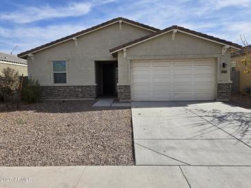 Charming single-story home featuring a two-car garage, low maintenance yard and a neutral color palette at 7321 N 123Rd Dr, Glendale, AZ 85307