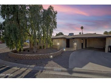 Charming single-story home with a mature tree and a well-manicured front yard at 734 S Edgewater Dr, Mesa, AZ 85208